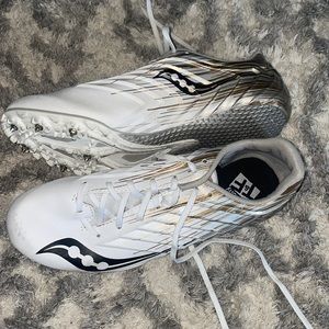 white and gold saucony track and felid shoe spikes